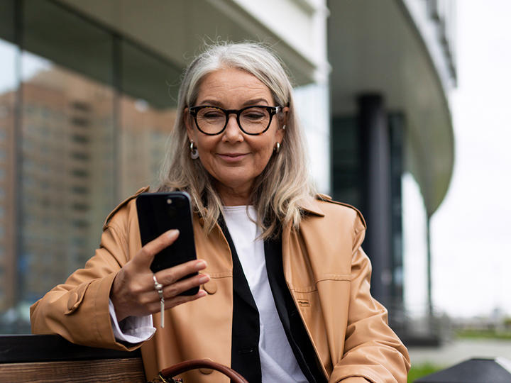woman looking at her phone screen