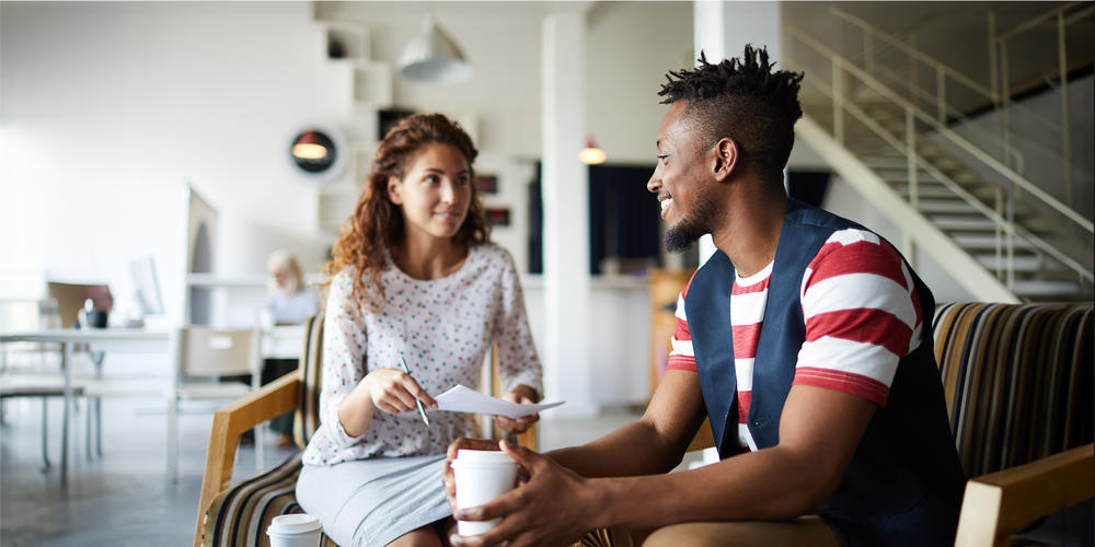 Two people looking at each other smiling